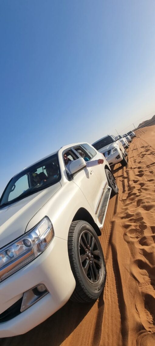 desert safari fleet SUV convoy getting ready for the sand bashing drive in the desert
