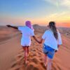 Couple on high sand dunes in dubai safari