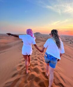 Couple on high sand dunes in dubai safari