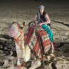 Female Tourist sitting on a camel on desert tour dubai