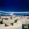 overnight desert safari dubai - desert-camp-lounge-night-string-lights-dubai.