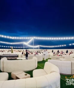 overnight desert safari dubai - desert-camp-lounge-night-string-lights-dubai.
