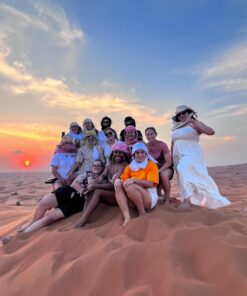 group photo of tourists on a high dune desert - Desert Safari Dubai