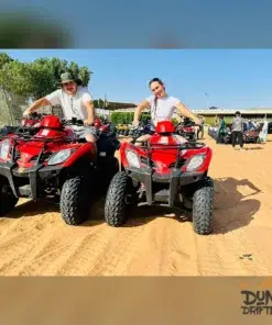 guests-riding-red-quad-bikes-dubai-desert for Evening Desert Safari with Quad Bike - dubai desert experience _ website handle handle by Mustajabhub.com