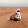 sandboarding over the high dunes in desert safari