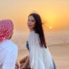 couple at sunset point in desert safari