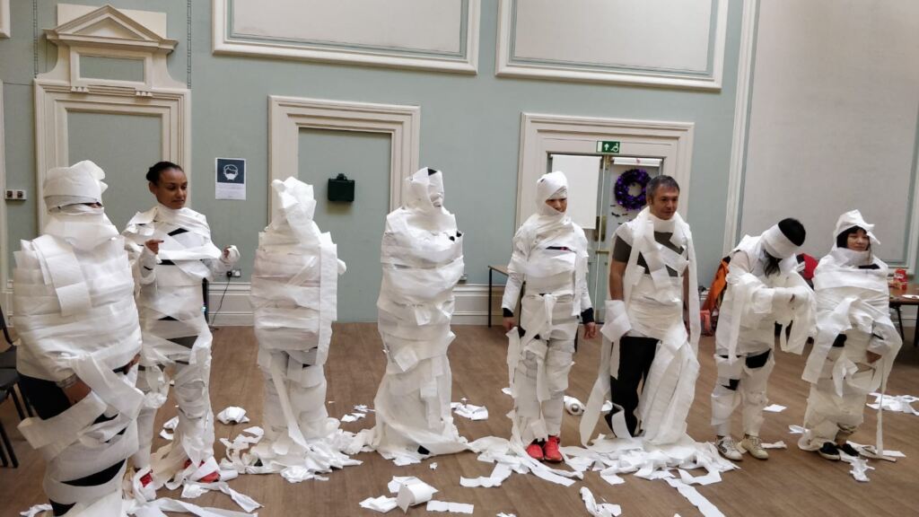 tissue paper wrap mummy team building activities - Desert Safari Dubai