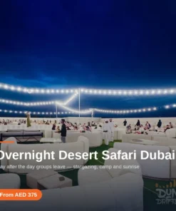 Overnight desert safari camp lit at night in the Lahbab dunes, Dubai